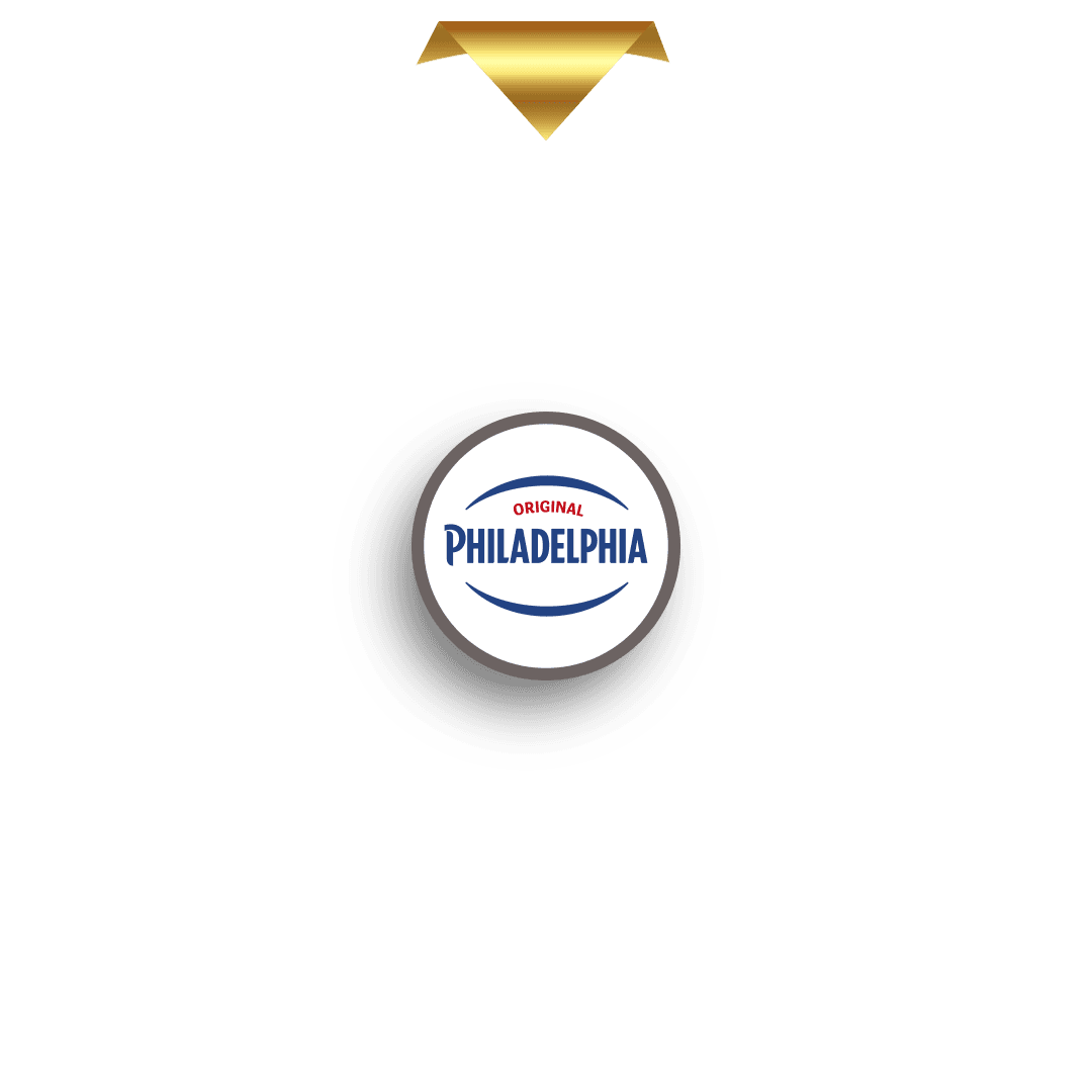 En guldpekare i form av en nedåtriktad triangel är placerad ovanför en cirkelformad markör med en stiliserad, glittrande guldbokstav "M" i mitten. Markören kastar en skugga och är utformad för att ligga i linje med det övre segmentet på ett prishjul (visas inte på denna bild).